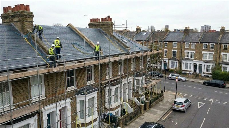 Complete slate re-roof in progress on a London terrace